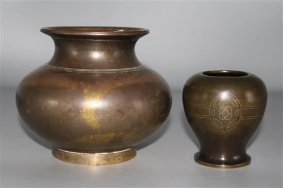 A bronze vase and a smaller bronze vase